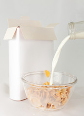 Opened cornflakes box with milk