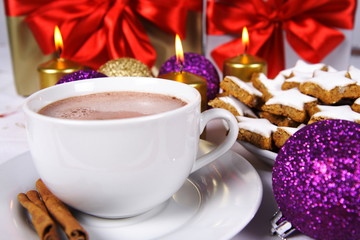 Hot chocolate with cinnamon sticks and cookies