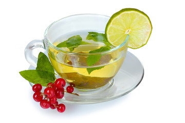 green tea in transparent cup with lime and berry
