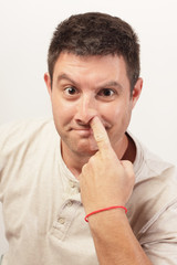 Image of a man picking his nose