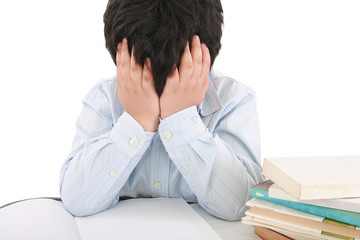 Obraz premium Schoolboy being stressed by his homework, isolated on white back