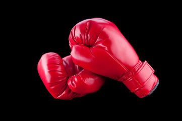Red boxing gloves isolated on black