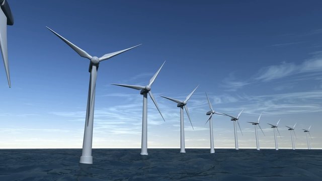Wind turbines offshore on ocean with a blue sky