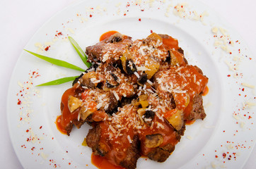 Meat served with sauce in the plate