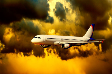 Airplane on sunset sky