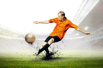 Naklejka premium Football player on field of stadium