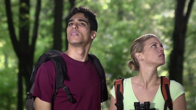 young couple looking at map during trek after losing orientation