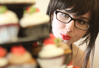 Cute girl anticipating eating a gourmet cupcake.