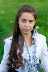 teen siting on the green grass