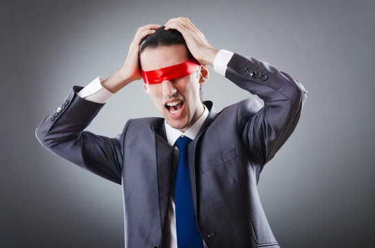 Businessman blinded by red tape