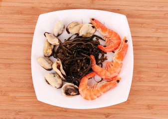 seafood on plate on brown background