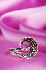 Jewellery ring on the satin background