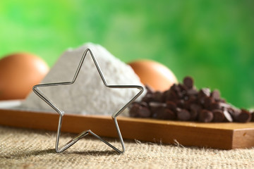 Star-shaped cookie cutter with baking ingredients