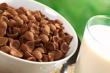Chocolate wheat flake cereal with a glass of milk