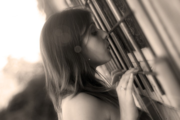curious woman looking through a window