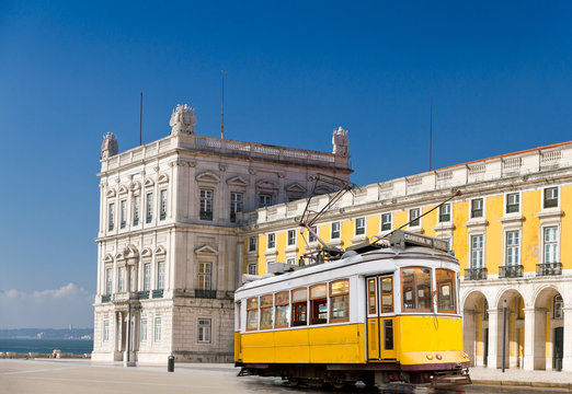Lisbon yellow tram at central square Praca de Comercio, Portugal