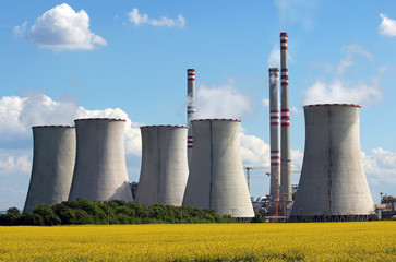 view of coal power plant over yellow agriculture field