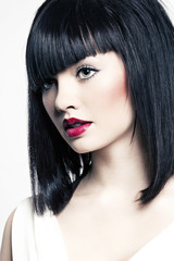 beautiful girl with perfect skin, red lipstick and black hair