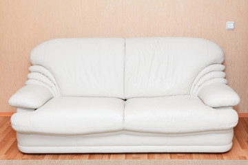 White leather couch in the room interior. Nobody