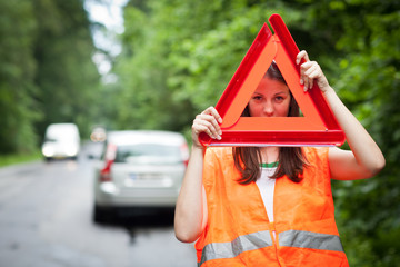 Young female driver wearing a high visibility vest