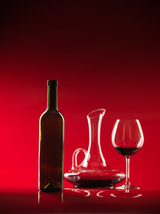 glass of red wine, bottle and pitcher