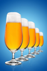 Beer glasses on blue background