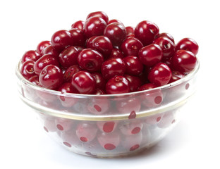 Bowl with ripe cherries. Isolated on a white background.