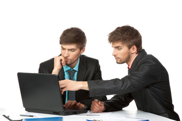 Fototapeta premium Two business people in elegant suits sitting at desk working