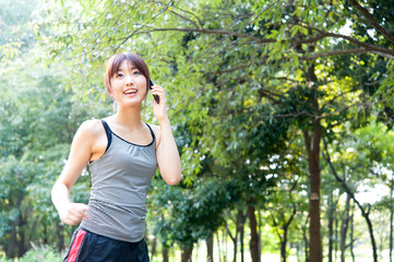 beautiful asian woman running in the park
