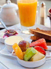 Breakfast with orange juice and fresh fruits