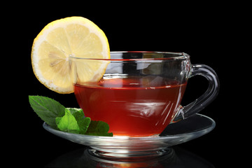 tea with lemon and mint on black background