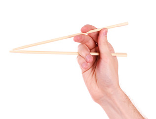 hand and wooden chopsticks isolated on white