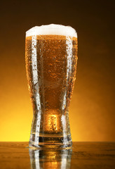 Glass of beer on dark background
