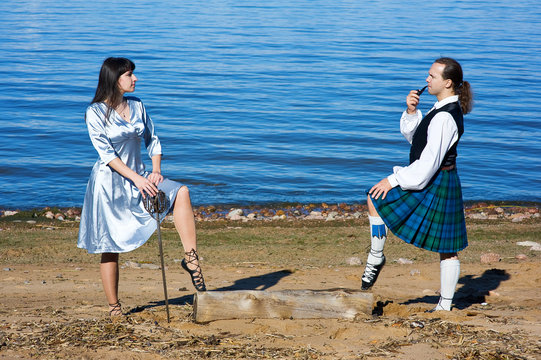 Woman with sword and man in scottish costume