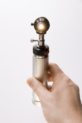 Hand Holding Medical Equipment Otoscope