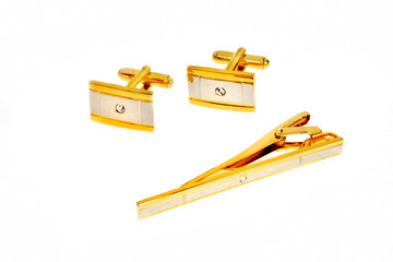 golden cuff link and tie pin isolated on white background