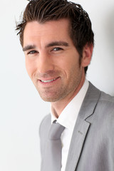 Portrait of businessman on grey background