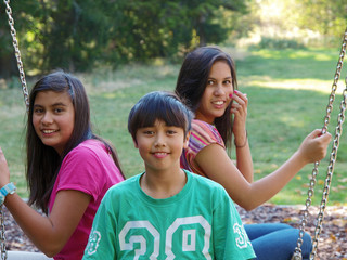 smiling kids on the swing