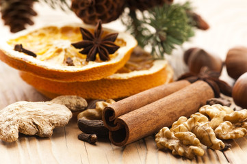 Different kinds of spices, nuts and dried oranges - christmas de