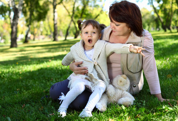 Fototapeta premium Grandmother with her little granddaghter in park
