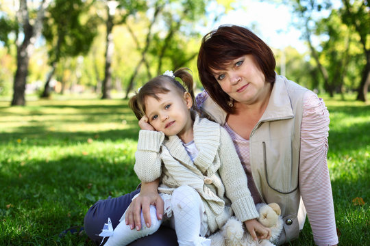 Grandmother with her little granddaghter in park