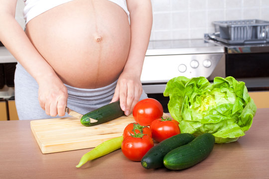 Pregnancy and nutrition - pregnant woman with vegetables