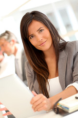 Beautiful businesswoman using electronic tablet