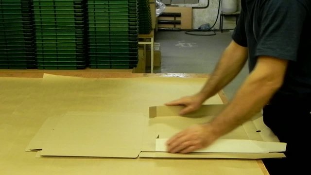 Assembling the packing boxes in a warehouse.