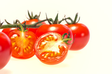 Sliced cherry tomato close up, isolated on white background