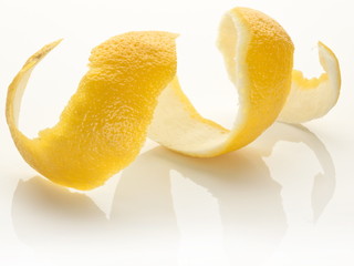 Twist of citrus peel on a white background.