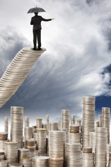 businessman stand on the coins  watching the storm