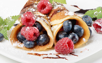 pancakes topped with blueberries,raspberries, mint and Powdered