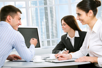 Handsome happy business man with colleagues