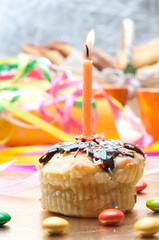 cupcake with sprinkles and candle